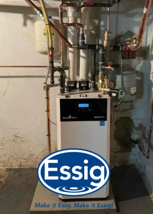A white boiler unit is installed in a basement with various pipes connected, highlighting expert Boiler Installation; the Essig company logo and slogan are overlaid at the bottom of the image.
